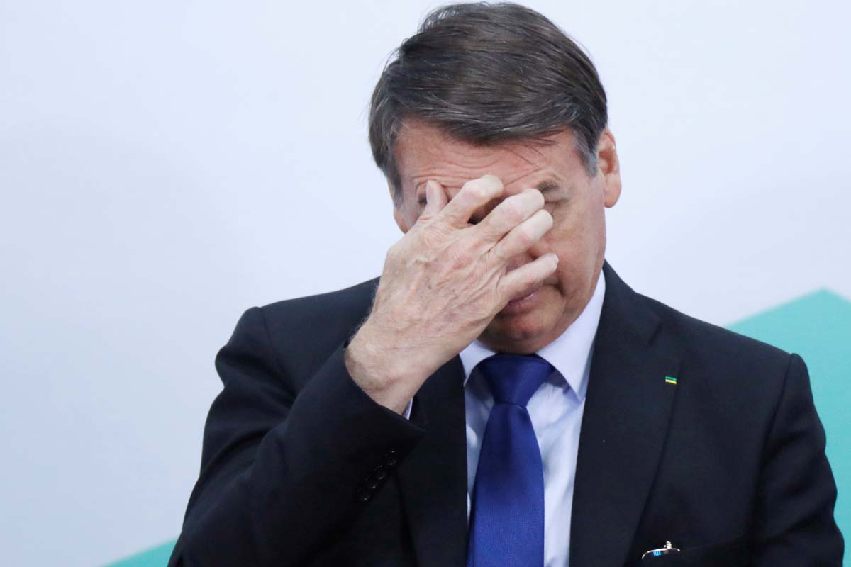 Brazil's President Jair Bolsonaro reacts during a signing ceremony of a presidential decree providing federal organisations with free of charge publications by National Press, in Brasilia
